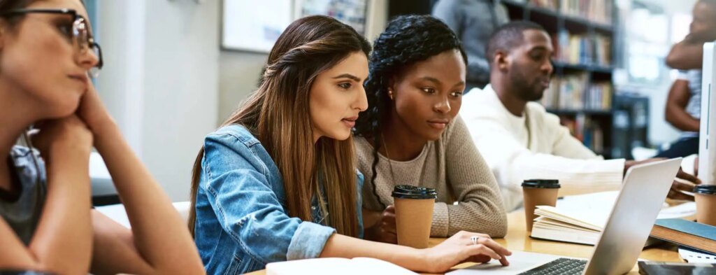 Students working together on a laptop during a study session