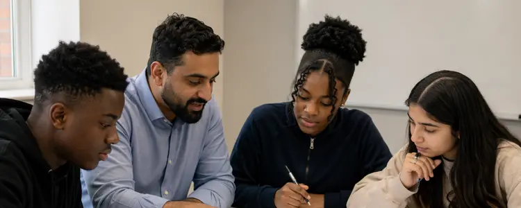 Tutor helping secondary students during a focused lesson