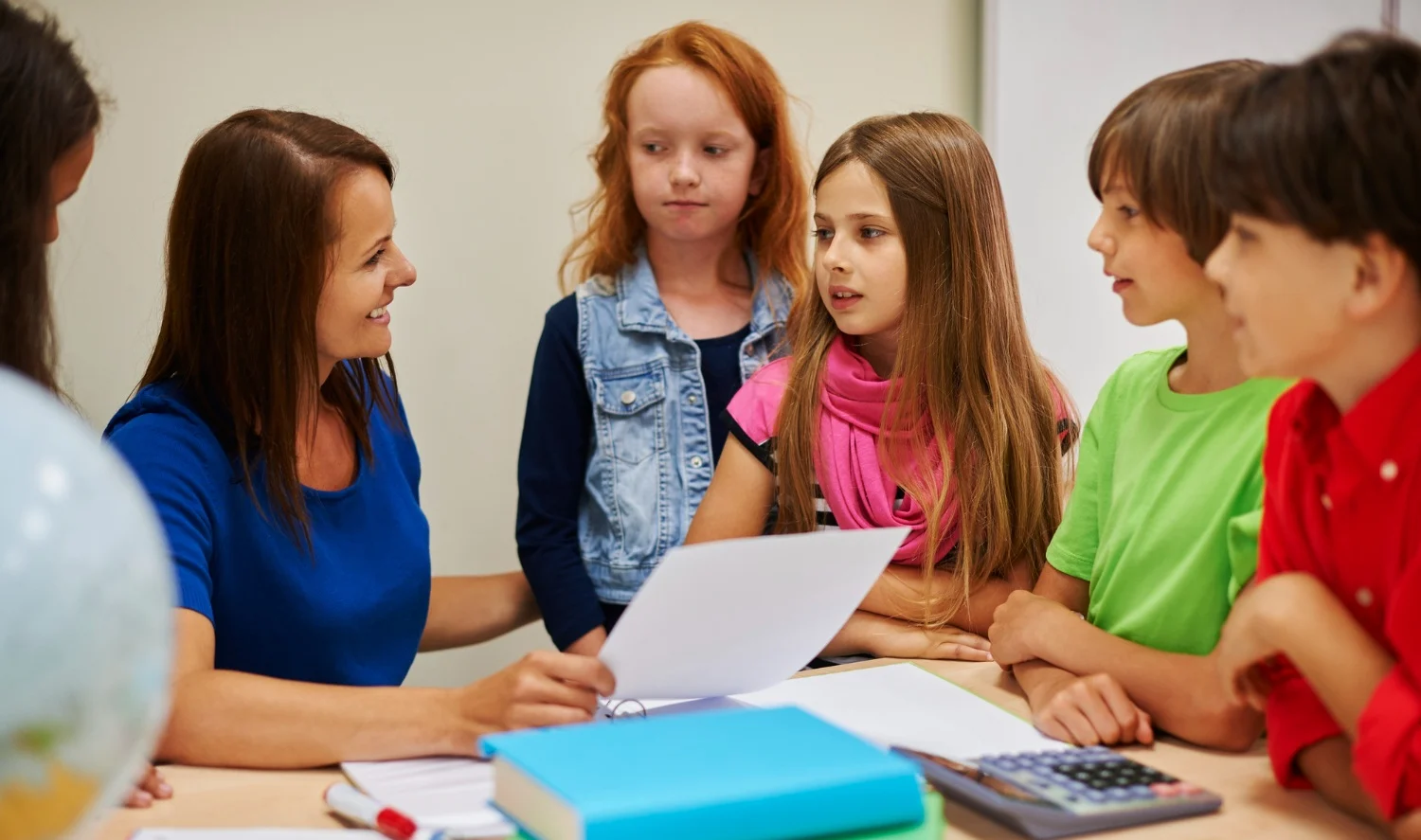 Tutor facilitating a micro-group of three primary pupils in Milton Keynes.